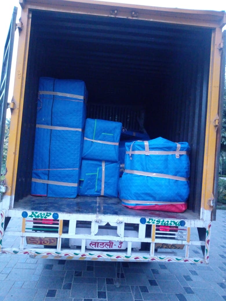 Truck loaded with furniture wrapped in protective foam sheets for safe household shifting by Mohija Packers and Movers Delhi.